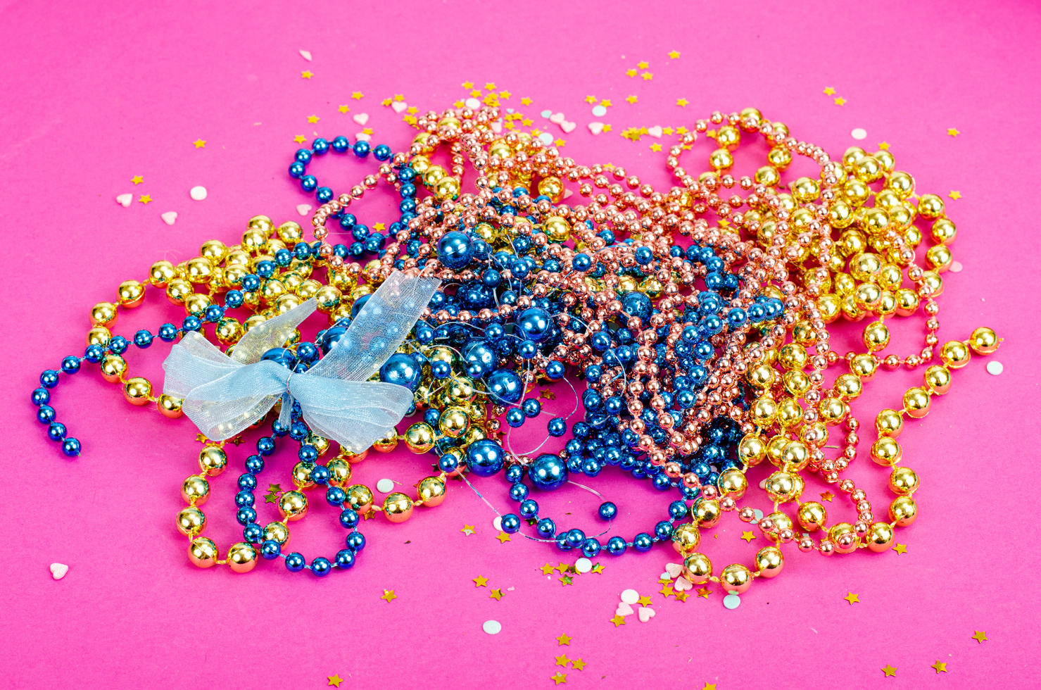 Color Mardi Gras Beads, Masks on Bright Background. Studio Photo