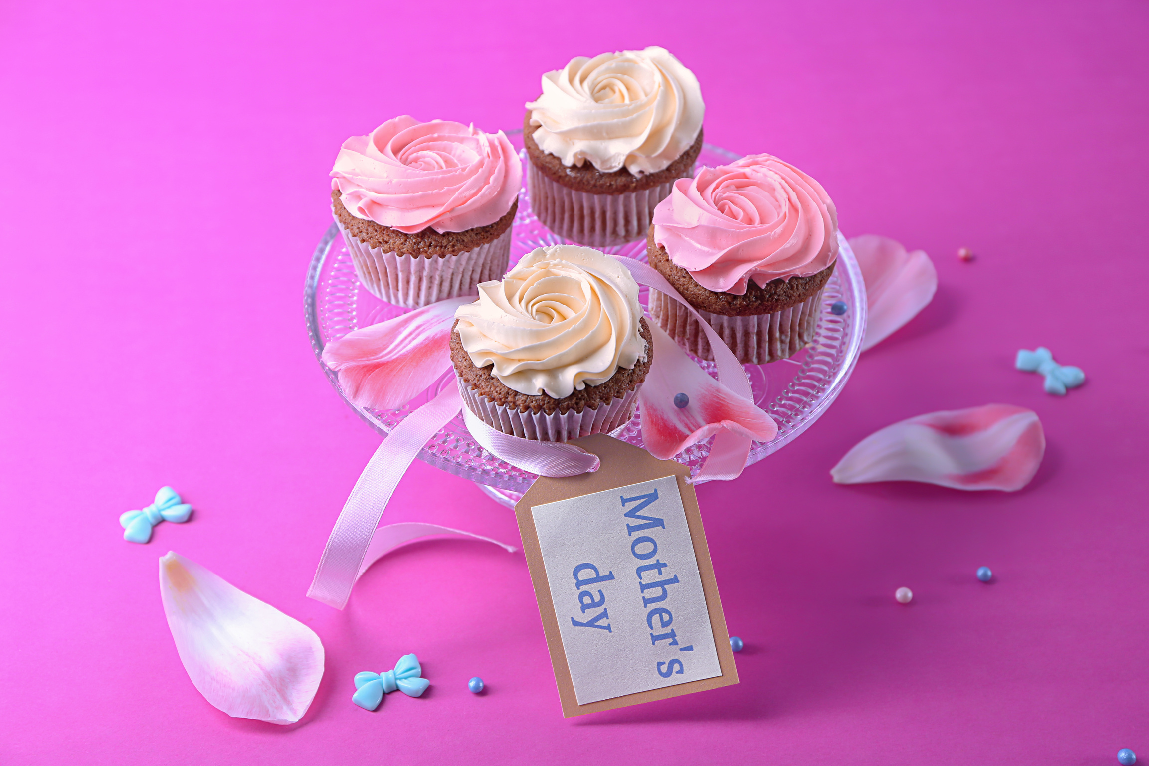 Dessert Stand with Tasty Cupcakes on Color Background. Mother's Day Celebration