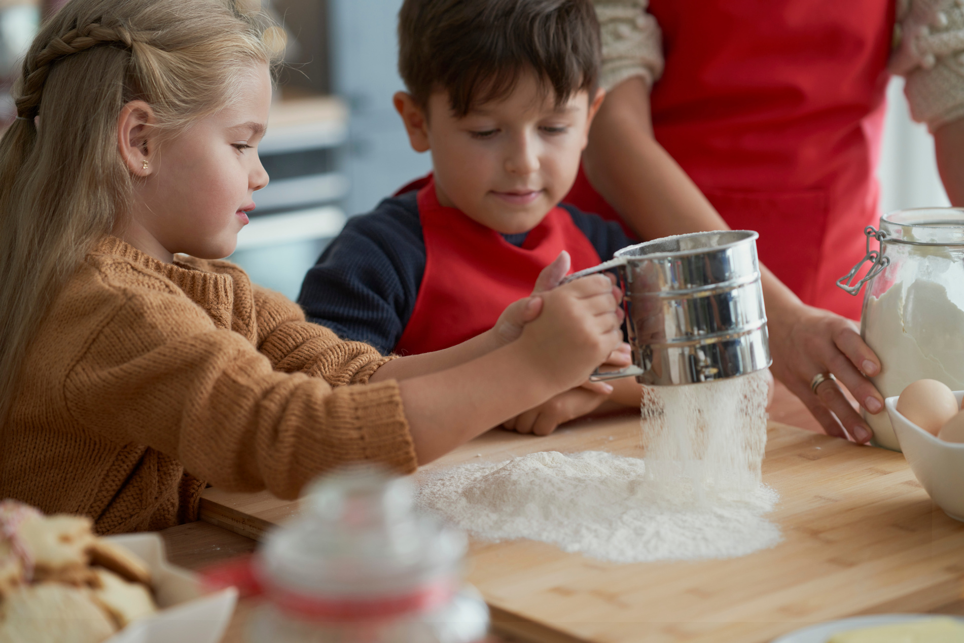 Children Sieving Flour in the Kitchen