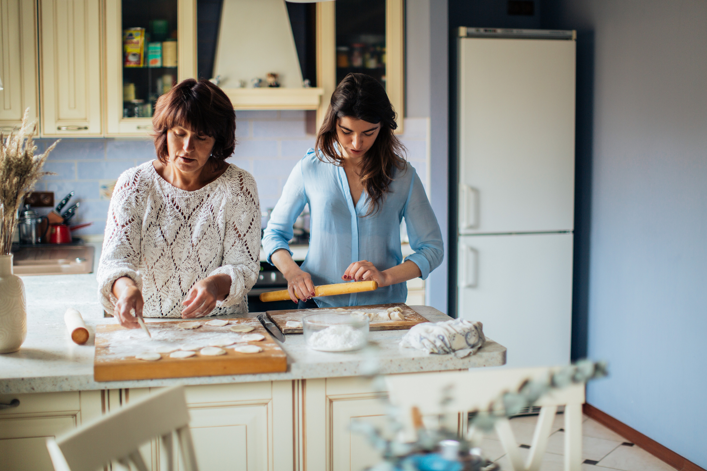 Women Making Dumplings In The Kitchen